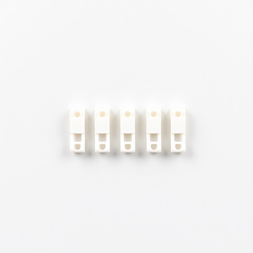 Charcoal cable clips arranged on a natural wood desk.